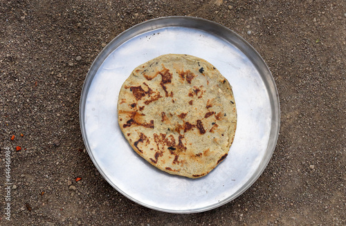 Gujarati traditional sorghum ki roti or pearl millet flat bread. farmer's lunch or common items eaten in lunch which are bajre ki roti. Jowar Roti or Indian bread, eaten by working class in rural area photo