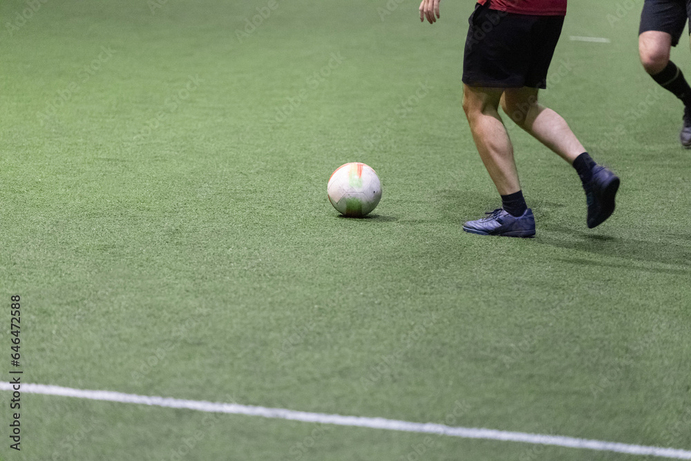 Players in action on futsal match. Indoors hall with artificial turf. Sport concept. Players in action on futsal match. Indoors hall with artificial turf. Sport concept.