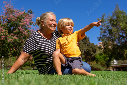 grandmother and grandson are walking in the park on a summer day