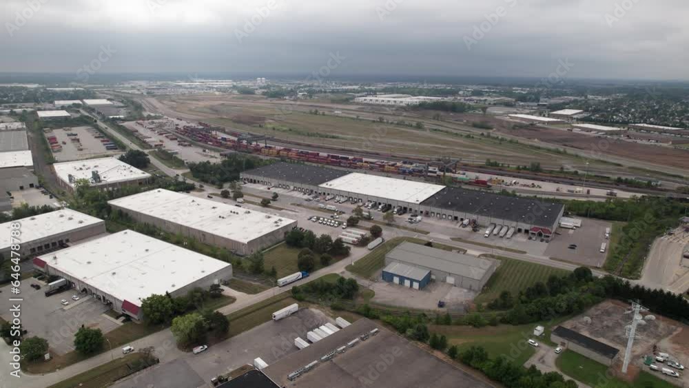 Drone and Aerial Establishing Landscape View of Semi Truck and Shipping Freight Facility for Commercial Trucking Near Railroad Tracks at Midwest, USA Location Drone and Aerial Establishing Landscape View of Semi Truck and Shipping Freight Facility for Commercial Trucking Near Railroad Tracks at Midwest, USA Location