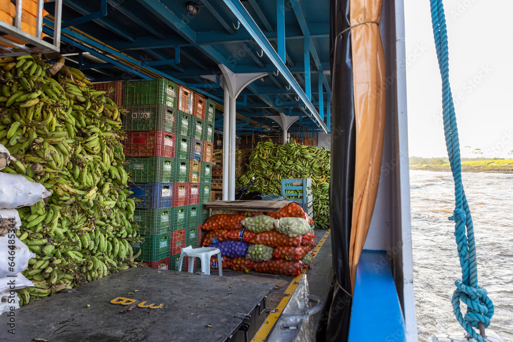 Stacked boxes with tropical fruits, bags and heaps of green bananas on a ferry to Manaus in Brazil, South America