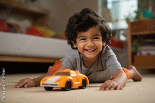 Indian small kid playing with toy car at home, happy expressions