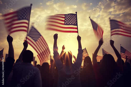 Silhouettes of people holding the american flag on sunset background photo