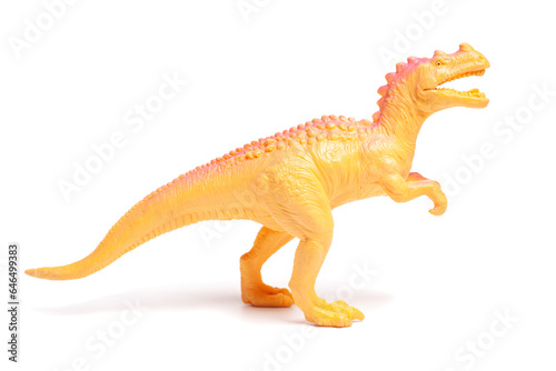 Yellow dinosaur toy isolated on white background.