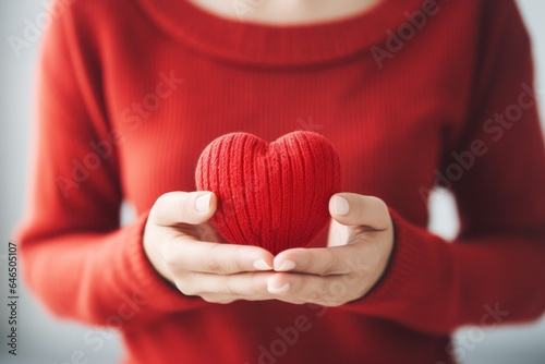 Red heart in womens hand