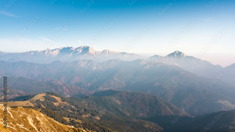 Astonishing scene of mountain range horizon in the morning mist, illuminated by the light of the rising sun, aerial shot. The majestic beauty of nature concept. Astonishing scene of mountain range horizon in the morning mist, illuminated by the light of the rising sun, aerial shot. The majestic beauty of nature concept.