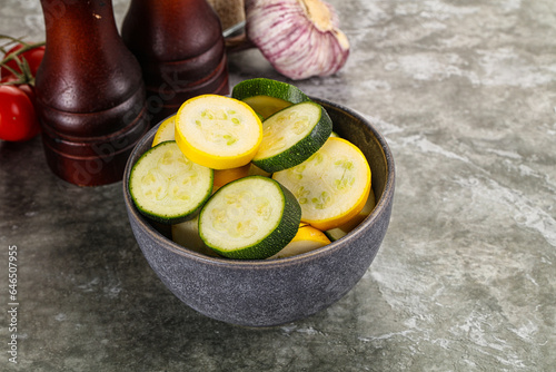 Sliced raw young green and yellow zucchini