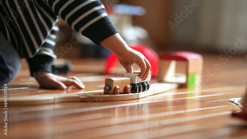 Close-up of Kid's Hand with Retro Toy Railroad, Boy Playing with Vintage Train Set at Home