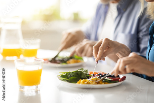 Breakfast Time. Unrecognizable Mature Couple Eating Morning Meal In Kitchen