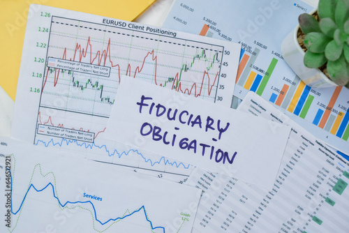 Concept of Fiduciary Obligation write on sticky notes isolated on Wooden Table.