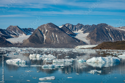 Stunning landscapes with jagged mountain peaks, glaciers and icebergs along the shores of the Liefdefjorden, Northern Spitsbergen, Svalbard, Norway photo