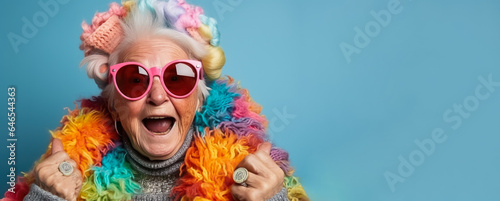 Old woman in full knitted cozy costume isolated on vivid background with a place for text 
