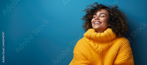 Woman in full knitted cozy costume isolated on vivid background with a place for text 