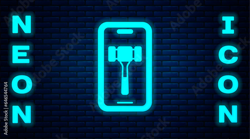 Glowing neon Online auction icon isolated on brick wall background. Bid sign. Auction bidding. Sale and buyers. Vector