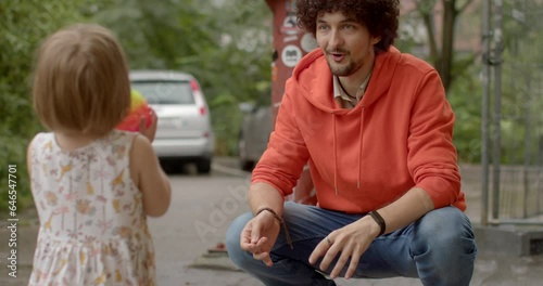 Parent with child. Natural parenting modern trend where young fathers actively engage with their children, playing, making eye contact, emphasizing emotional connection and nurturing.