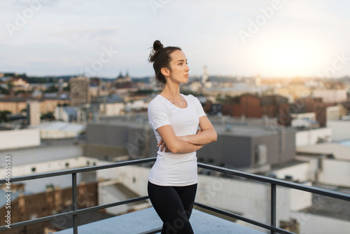Lady relaxing after outdoor workout on panoramic terrace