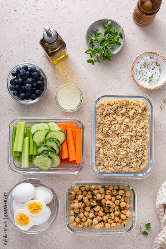 Vegetarian lunch meal prep in containers, high protein with quinoa, herbed chickpeas, vegetables and boiled eggs