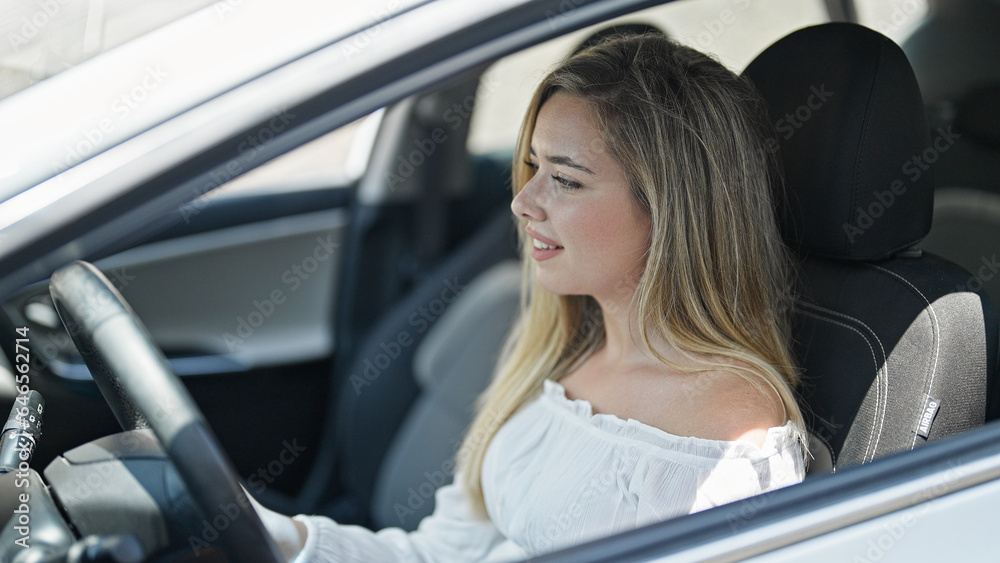 Young blonde woman smiling confident driving car at street Young blonde woman smiling confident driving car at street