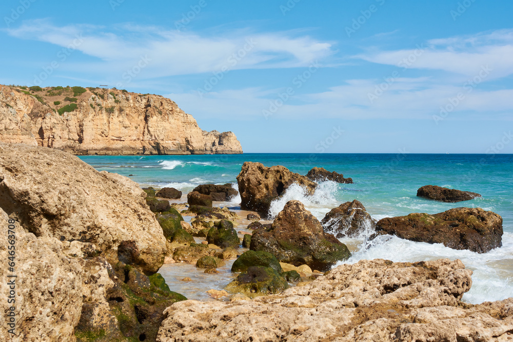 Huge cliffs and limestone rocks washed by the ocean waves. Lagos, Portugal