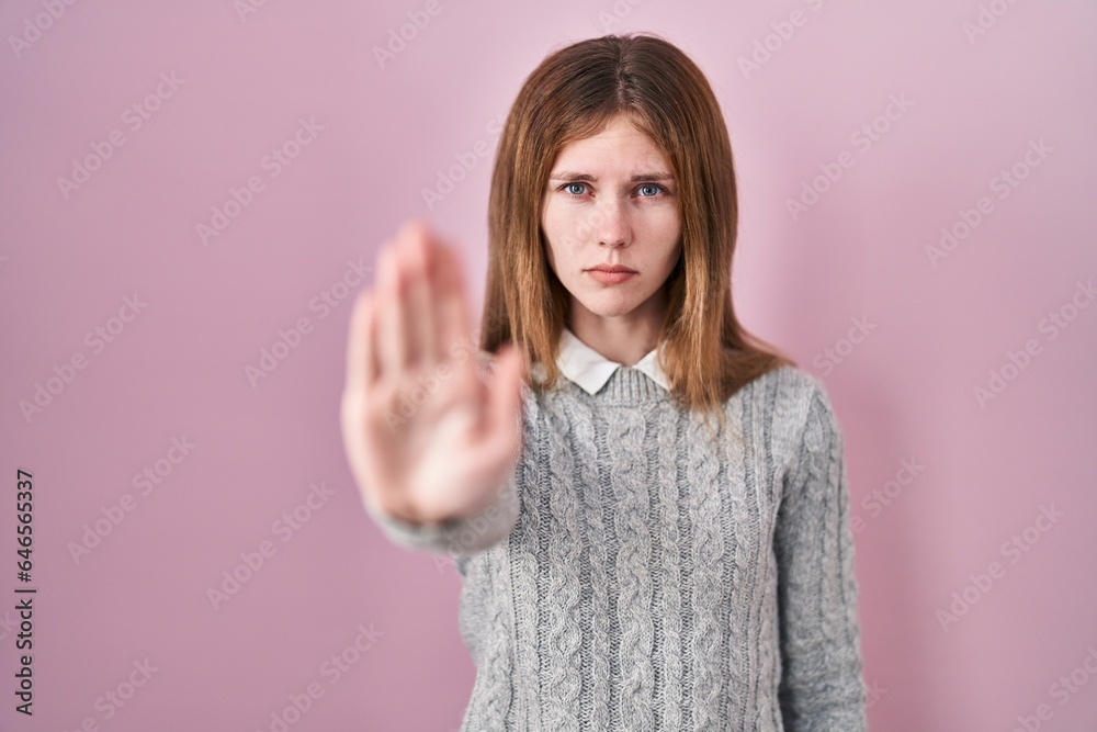 Beautiful woman standing over pink background doing stop sing with palm of the hand. warning expression with negative and serious gesture on the face. Beautiful woman standing over pink background doing stop sing with palm of the hand. warning expression with negative and serious gesture on the face.
