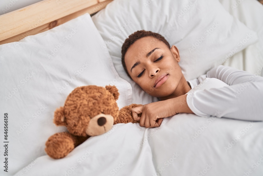 African american woman hugging teddy bear lying on bed sleeping at bedroom African american woman hugging teddy bear lying on bed sleeping at bedroom