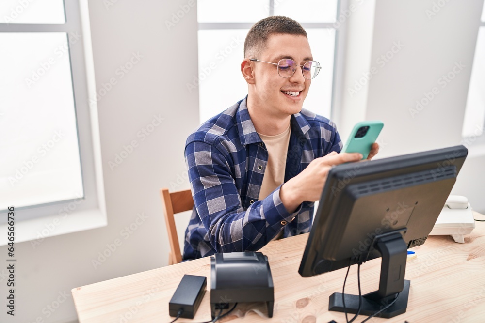 Young hispanic man ecommerce business worker using smartphone at office Young hispanic man ecommerce business worker using smartphone at office