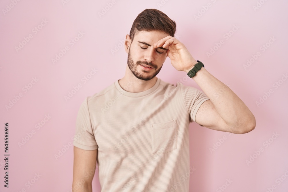 Hispanic man with beard standing over pink background worried and stressed about a problem with hand on forehead, nervous and anxious for crisis Hispanic man with beard standing over pink background worried and stressed about a problem with hand on forehead, nervous and anxious for crisis