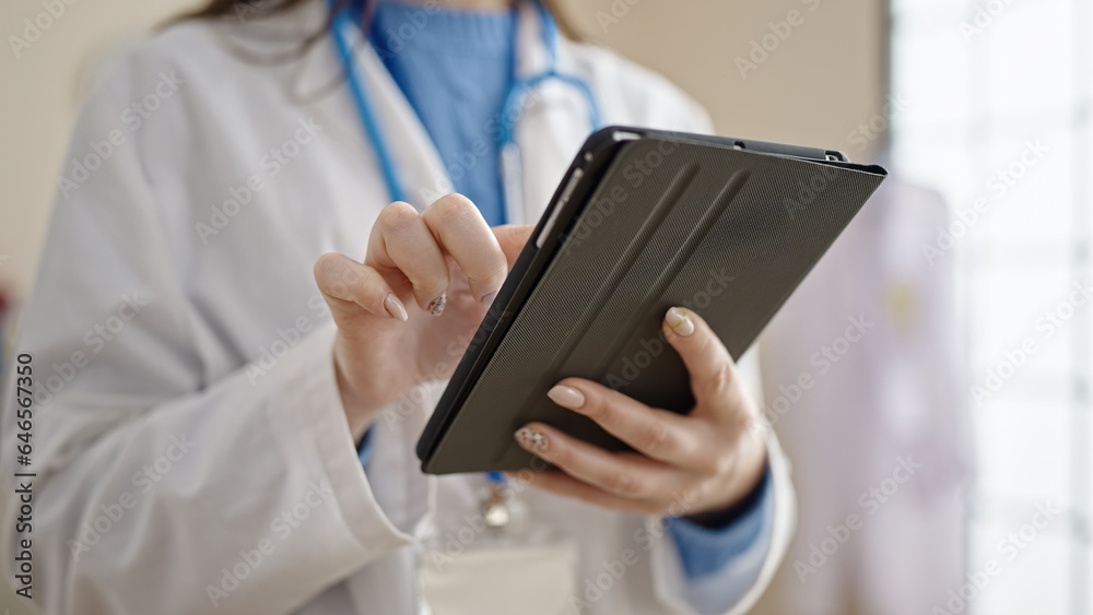 Young caucasian woman doctor using touchpad at clinic Young caucasian woman doctor using touchpad at clinic