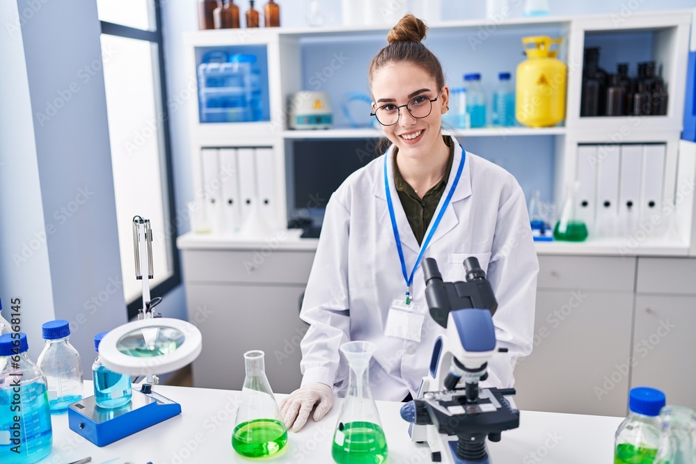 Young woman scientist smiling confident at laboratory Young woman scientist smiling confident at laboratory
