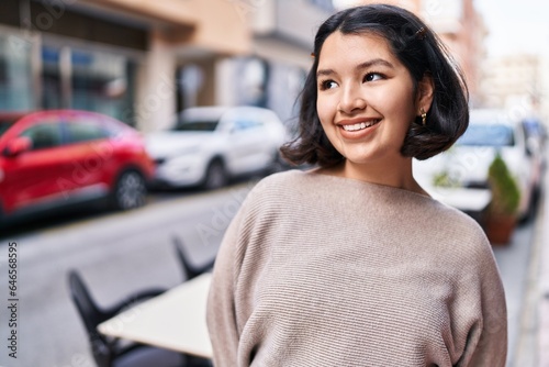 Young woman smiling confident looking to the side at street © Krakenimages.com