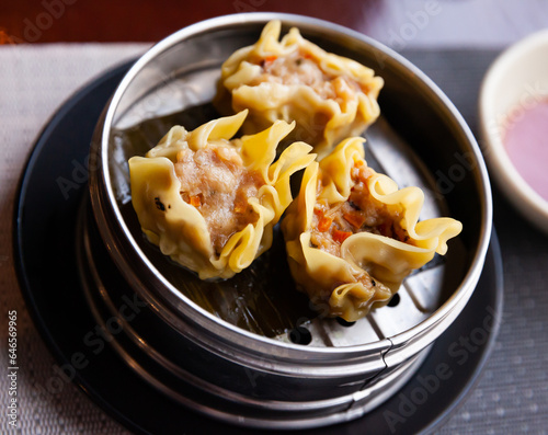 Steamed open dumplings Shumai with meat filling from pork with onion, carrot and mushrooms. appetizer