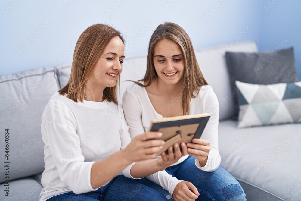 Two women mother and daughter looking photo at home Two women mother and daughter looking photo at home