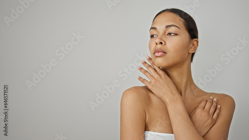 African american woman touching face standing over isolated white background