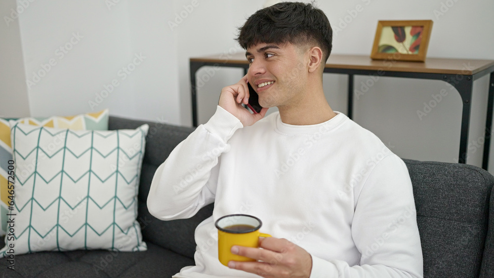 Young hispanic man talking on smartphone drinking coffee at home Young hispanic man talking on smartphone drinking coffee at home