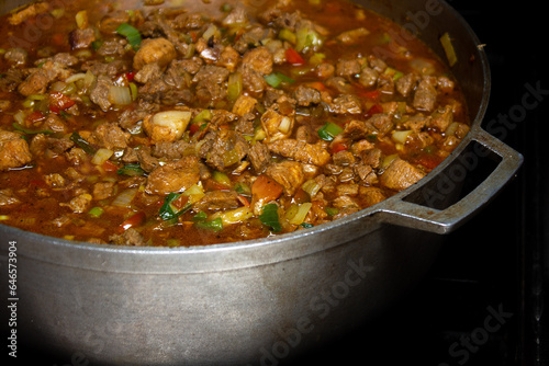 Slika na platnu Caldero in the kitchen with Stew prepared with beef, pork and chicken for hallacas