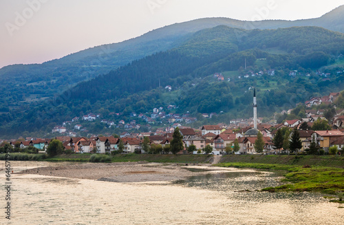 Gorazde residential district town panorama with mosque on the riverbank and Drina river in the foreground, Bosnia and Herzegovina photo