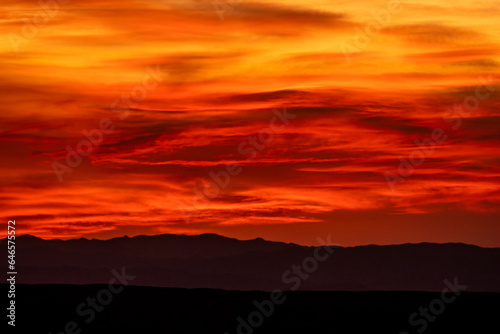 Brilliant Red and Orange Bands Through Clouds in Big Bend © kellyvandellen