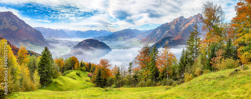 Fotografie, Obraz Outstanding autumn view on suburb of Stansstad city  and Lucerne lake with mountaines and fog
