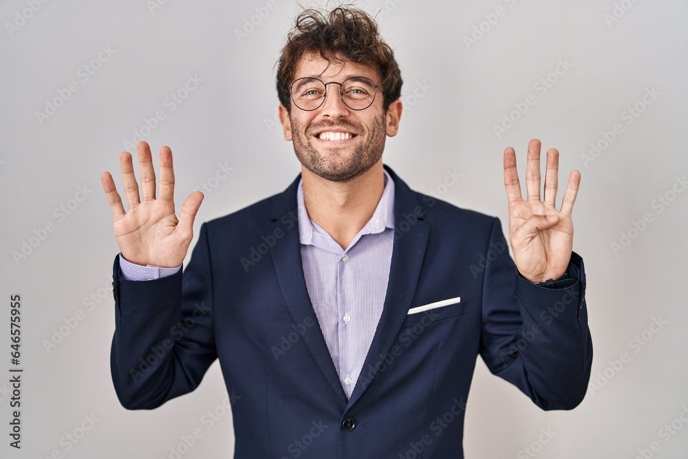 Hispanic business man wearing glasses showing and pointing up with fingers number nine while smiling confident and happy. Hispanic business man wearing glasses showing and pointing up with fingers number nine while smiling confident and happy.