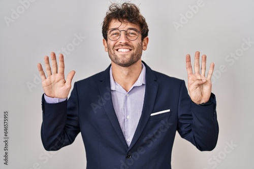 Hispanic business man wearing glasses showing and pointing up with fingers number nine while smiling confident and happy.