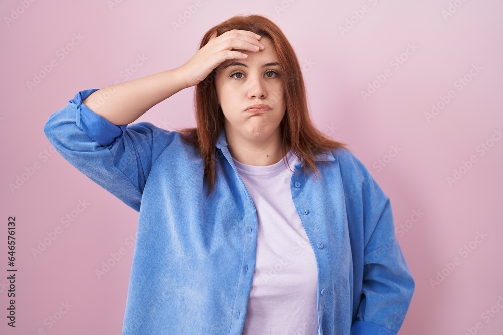 Young hispanic woman with red hair standing over pink background worried and stressed about a problem with hand on forehead, nervous and anxious for crisis Young hispanic woman with red hair standing over pink background worried and stressed about a problem with hand on forehead, nervous and anxious for crisis