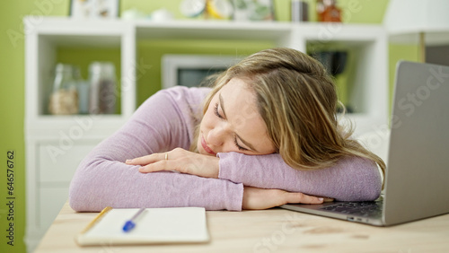 Young blonde woman sleeping on table at dinning room