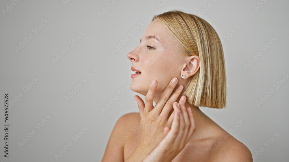 Young blonde woman massaging neck over isolated white background Young blonde woman massaging neck over isolated white background
