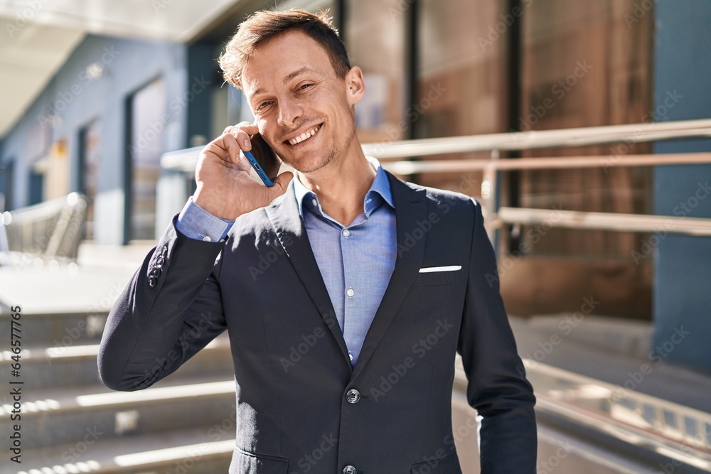 Young man business worker smiling confident talking on smartphone at street Young man business worker smiling confident talking on smartphone at street