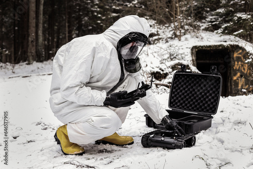 Wallpaper Mural a man in a chemical suit with a GCS ground control station. robot for searching radiation sources Torontodigital.ca