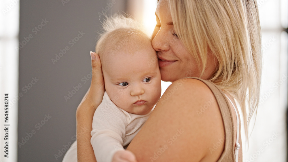 Mother and daughter hugging each other standing at home Mother and daughter hugging each other standing at home
