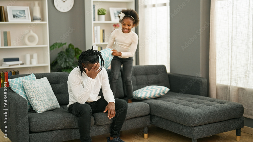 African american father and daughter sitting on sofa stressed for disturb at home