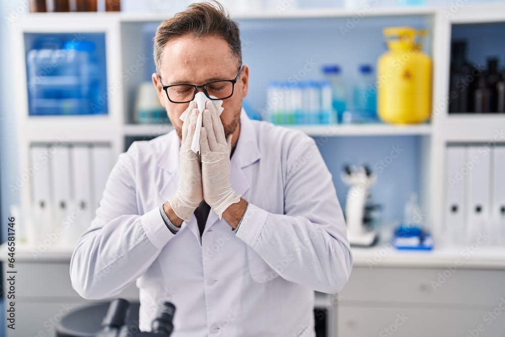 Young caucasian man scientist using napkin at laboratory Young caucasian man scientist using napkin at laboratory