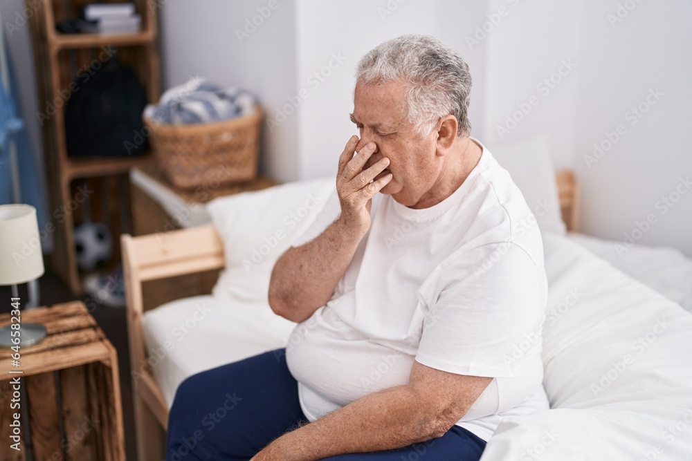 Middle age grey-haired man sitting on bed yawning at bedroom Middle age grey-haired man sitting on bed yawning at bedroom