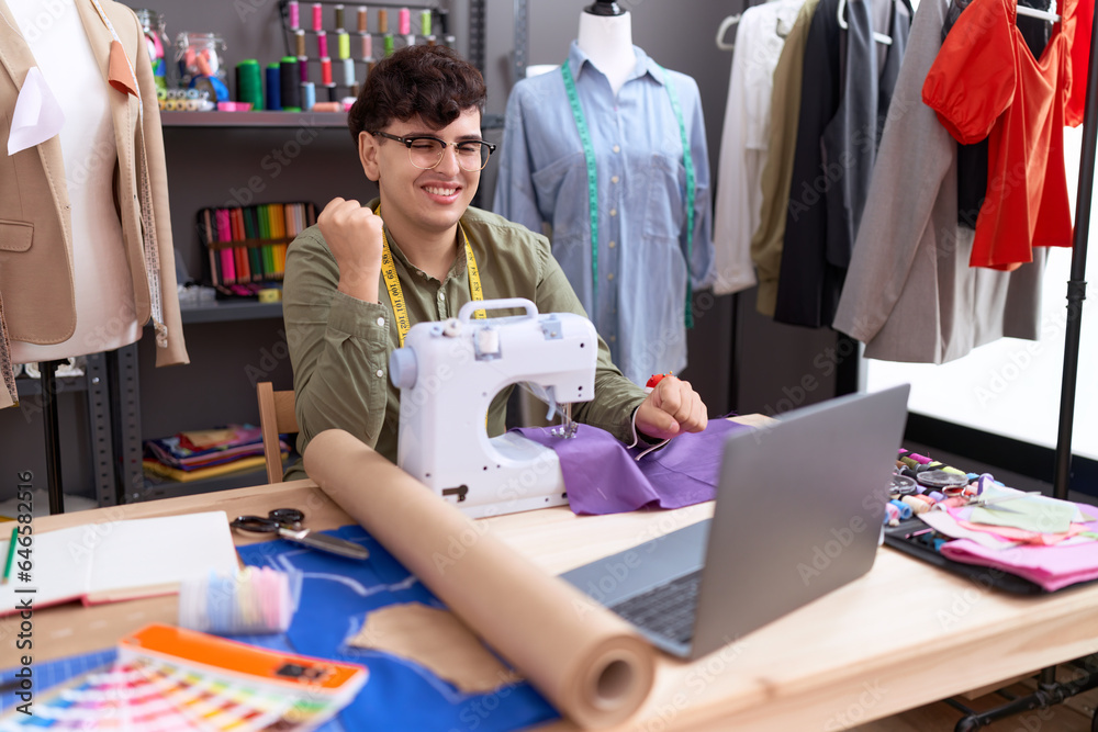 © Krakenimages.com - Young non binary man dressmaker designer on video call with laptop screaming proud, celebrating victory and success very excited with raised arm © Krakenimages.com - Young non binary man dressmaker designer on video call with laptop screaming proud, celebrating victory and success very excited with raised arm